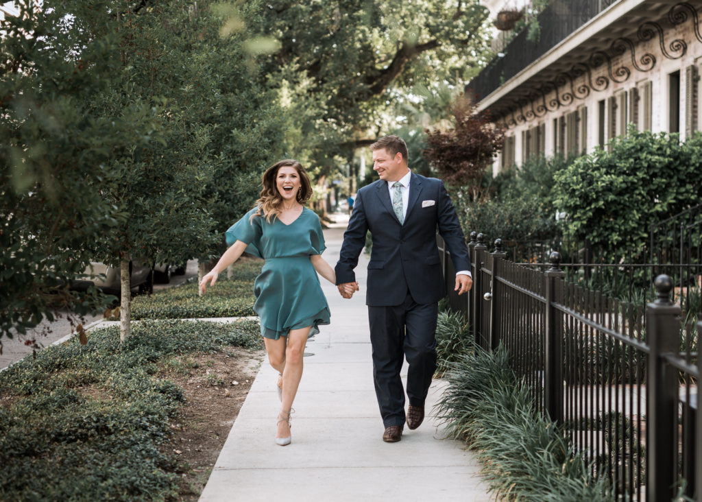 Stephanie Gaffney & husband smiling and running down sidewalk holding hands